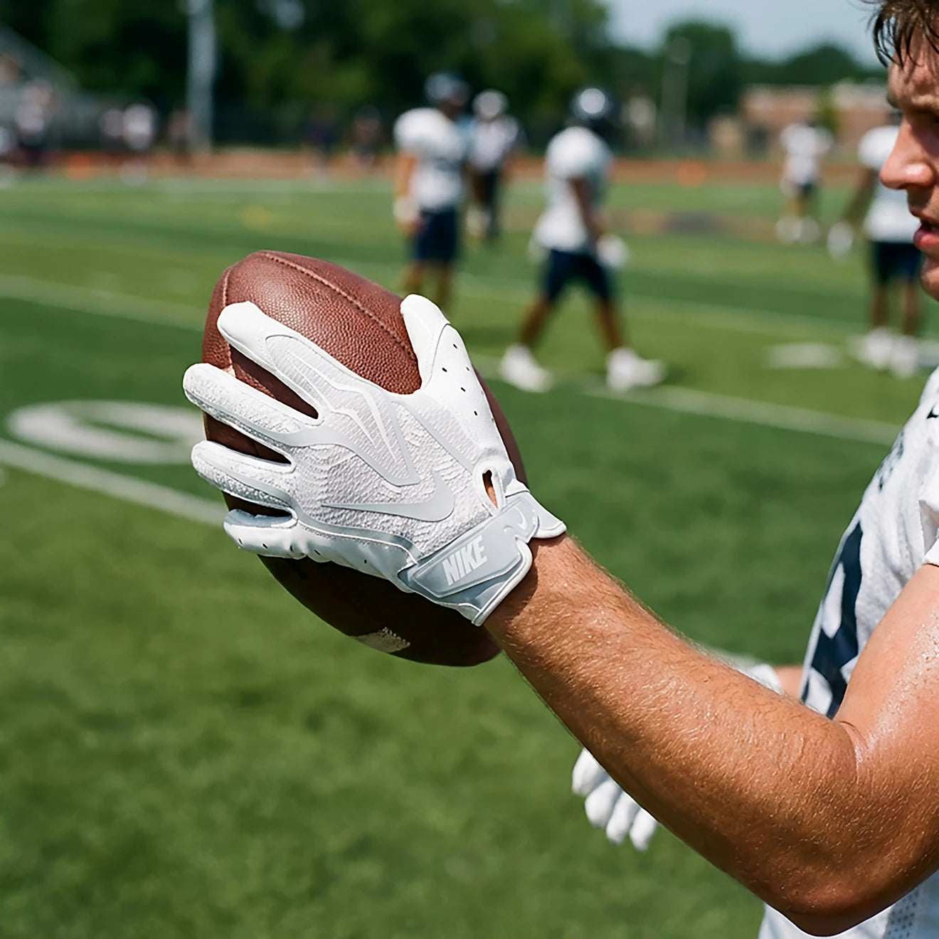 Athlete catching a football wearing white Nike Vapor Jet 9.0 gloves